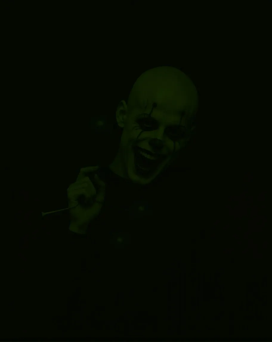 Horrifying  clown with blood streaming from its  mouth  clinging on to a hand full of black balloons  dark sinister invironment  with low light yet vibrant coloring evil smil